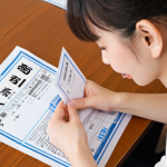 **

A student excitedly opening an envelope containing their JLPT N2 certificate. The scene should convey a sense of accomplishment and relief, perhaps with a study desk and Japanese textbooks subtly blurred in the background. Focus on the certificate itself, making it clearly visible.

**